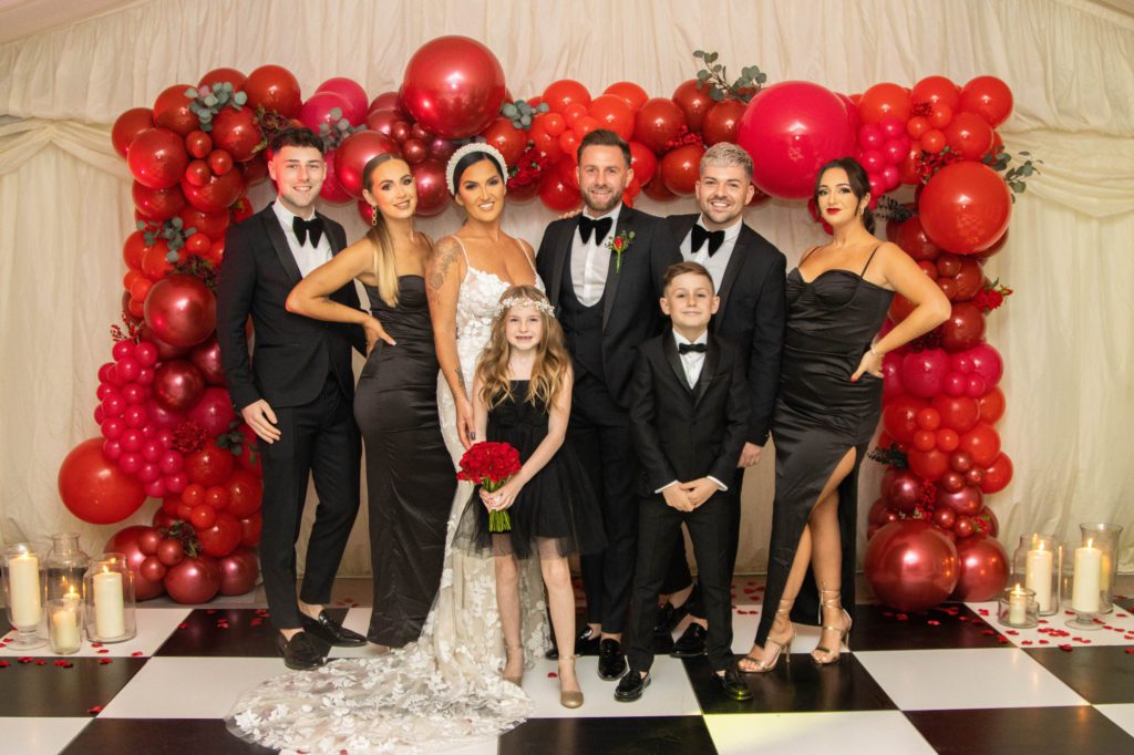 Bride and groom with wedding party at their after party in Buckinghamshire