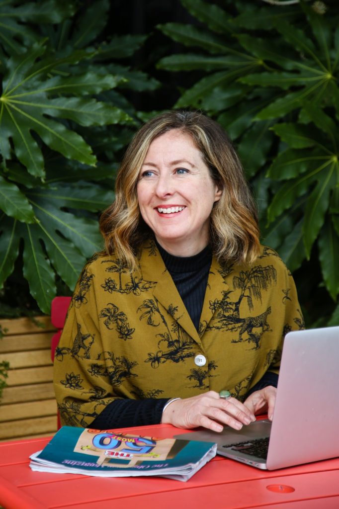 Relaxed headshot of Sarah Chambers Consulting with laptop in King's Cross London by Tanya Aldcroft Photography