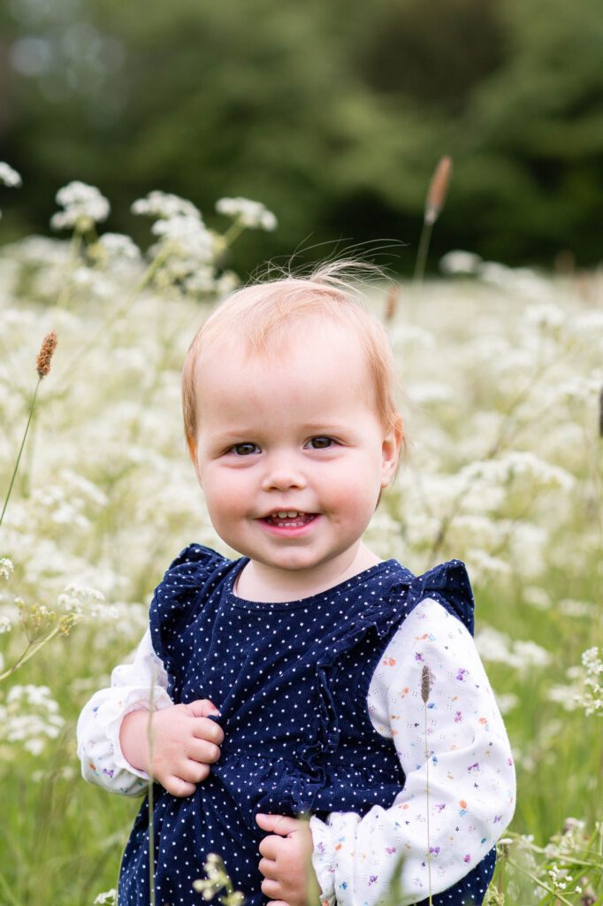 Baby girl in cow parsley meadow, Aston Clinton, Buckinghamshire by Aldcroft Photography