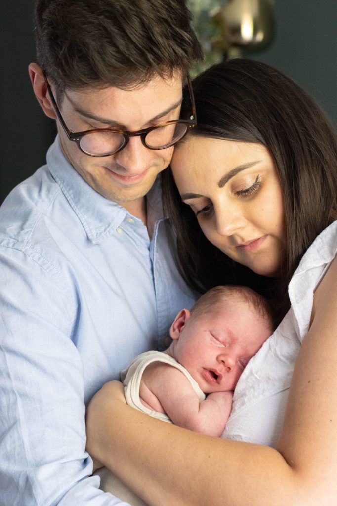 Mother and father with newborn baby boy at an in home family photo shoot, Tring, Hertfordshire