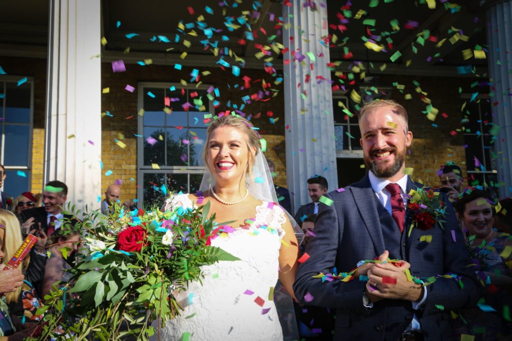 Photo of bride and groom in wedding confetti by Tanya Aldcroft Photography