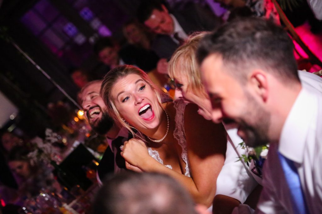 Photo of bride laughing at wedding reception by Tanya Aldcroft Photography