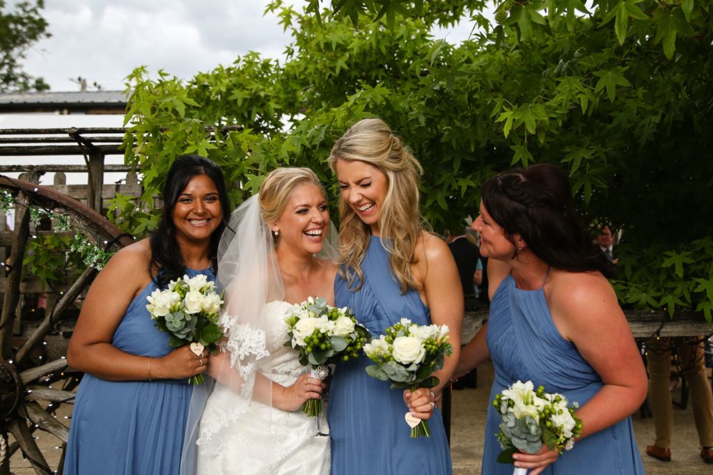 Photo of bride and bridesmaid laughing at wedding reception by Tanya Aldcroft Photography