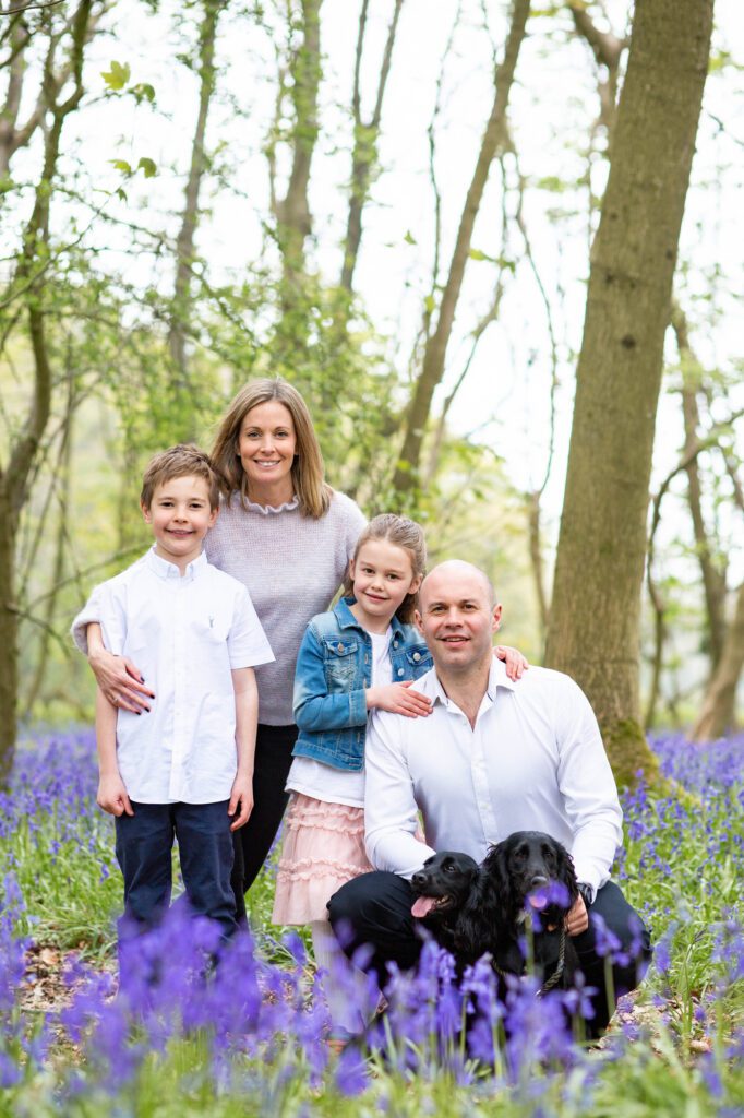 Relaxed family portrait with dogs at bluebell photo shoot near Tring, Hertfordshire by Aldcroft Photography